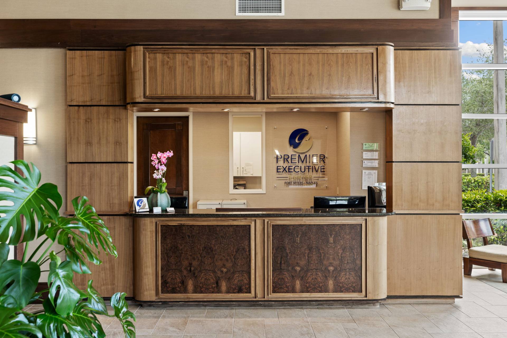 Reception desk offering mail handling, Microsoft support, and shipping support at Fort Myers office space.