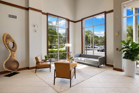 Naples business center lobby with lounge seating, polished interiors and welcoming office environment.